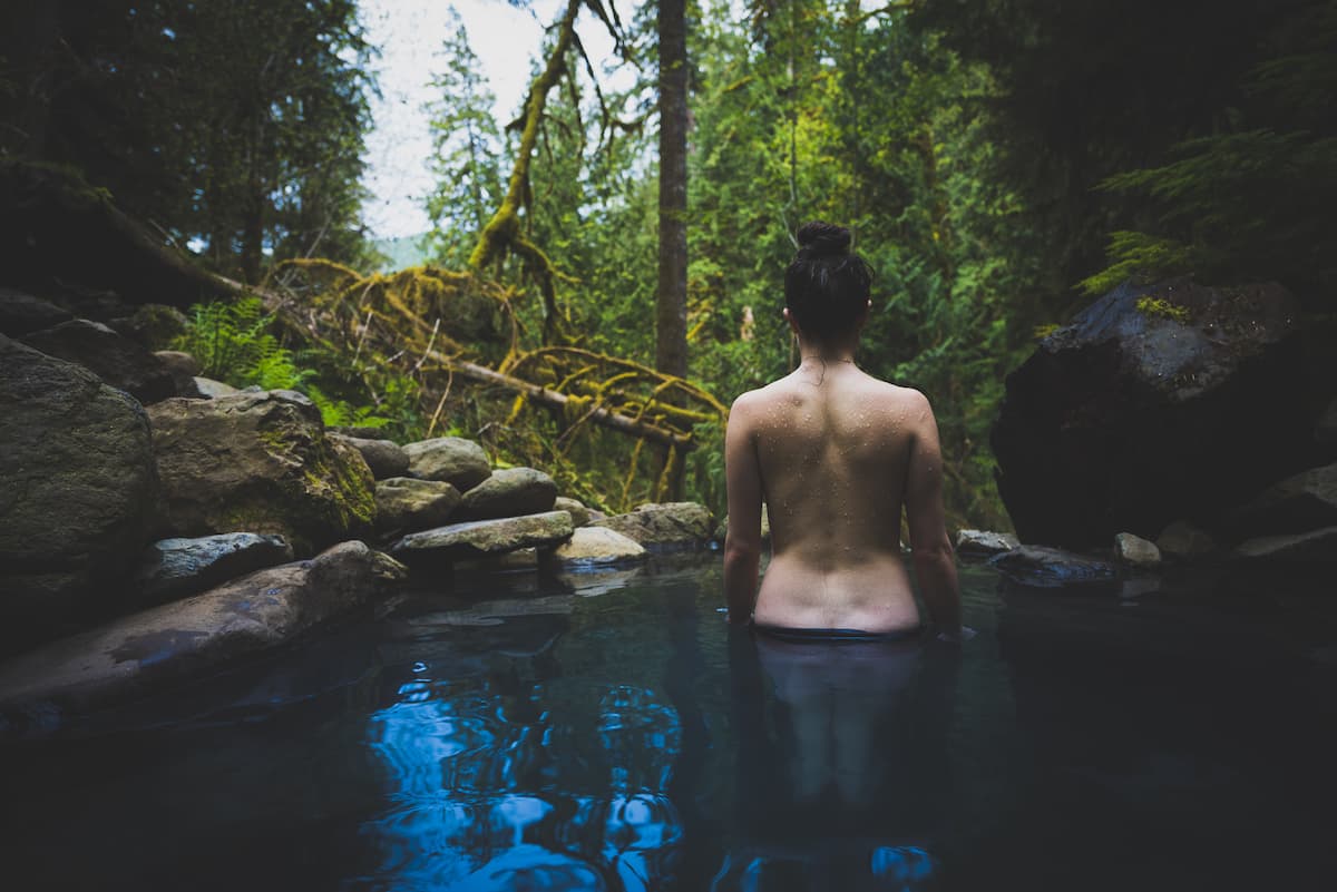 A woman soaking in Cougar Hot Springs in Oregon – Soak Oregon